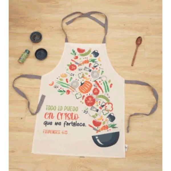 Delantal beige de algodón con ilustraciones de verduras y utensilios, que lleva un versículo bíblico en español: «Todo lo puedo en Cristo que me fortalece». Filipenses 4:13. Ideal como regalo cristiano para inspirar en la cocina.