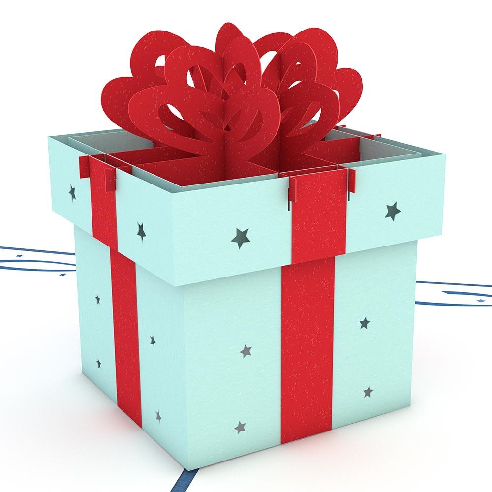 Una caja de regalo azul claro con un lazo rojo, decorada con pequeñas estrellas recortadas, descansa sobre una superficie blanca junto a una tarjeta de alta calidad, perfecta para regalar.