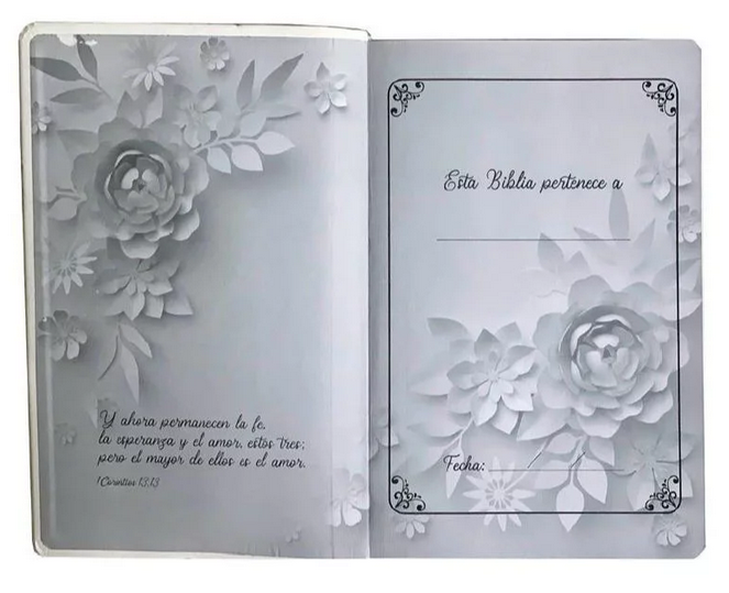 Biblia abierta con un diseño floral en relieve; la página izquierda muestra un versículo de la Biblia en español (RV 1960) y la derecha ofrece espacios para escribir el nombre del propietario y la fecha. Incluye la «Biblia letra gigante» para facilitar la lectura.