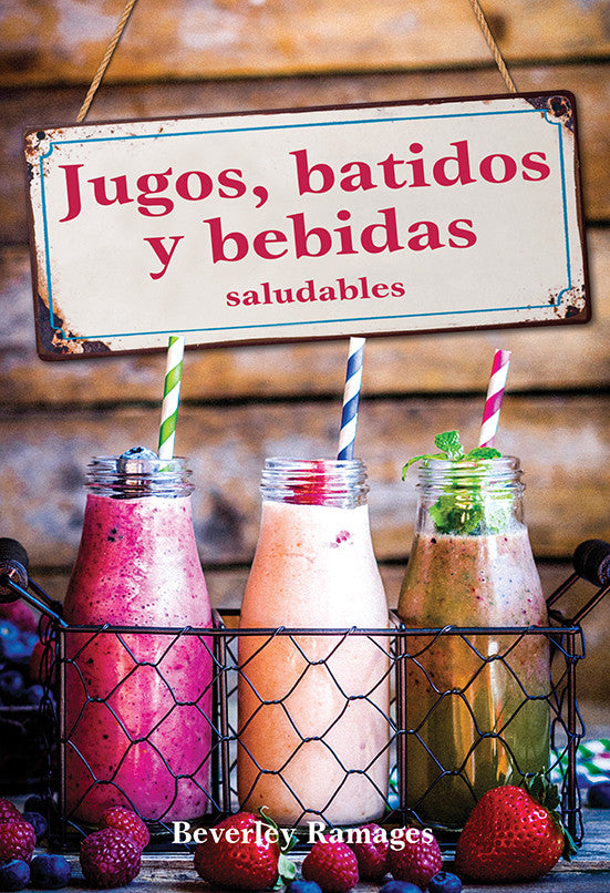 En una cesta de alambre se exponen tres botellas de cristal con bebidas naturales de colores y pajitas a rayas, con un cartel encima en el que se lee: «Jugos, batidos y bebidas saludables».