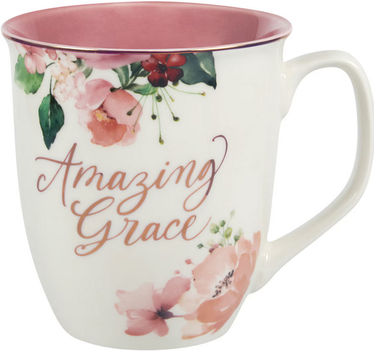 Taza de cerámica blanca con el interior rosa, motivos florales y la frase «Amazing Grace» impresa en letra cursiva. Cuenta con detalles metalizados y tiene una capacidad de 14 fl oz; se recomienda lavarla a mano para conservar su belleza.