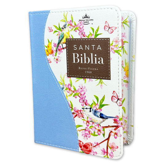 Una Biblia española RVR60 con una cubierta azul con motivos florales, en la que aparecen pájaros y mariposas. En la cubierta se lee: «Santa Biblia Reina-Valera 1960». Incluye las palabras de Jesús en rojo para una lectura más significativa.