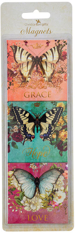 Un pack de tres imanes decorativos con forma de mariposa de la colección Secret Garden, con las inscripciones «Grace», «Hope» y «Love», cada uno con fondos florales de distintos colores y detalles brillantes en lámina dorada.