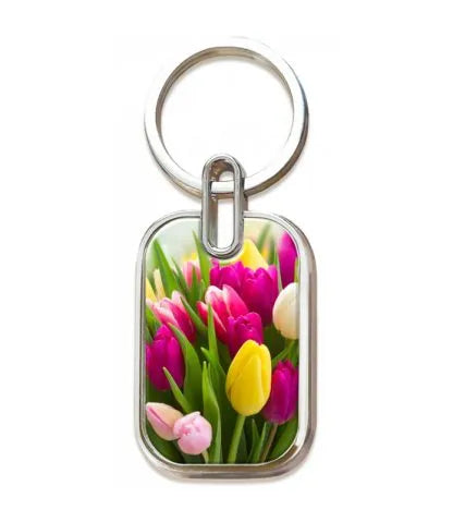 Un llavero metálico con una imagen de tulipanes en flor de color rosa, amarillo y blanco, inspirado en «el amor perfecto de 1 Juan 4:18, que echa fuera todo temor».