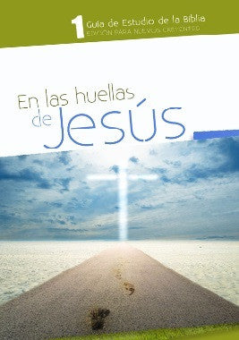 Portada de una guía de estudio bíblico titulada «En las huellas de Jesús», en la que se ve un camino que conduce hacia una cruz resplandeciente en el horizonte bajo un cielo azul, ideal para la Escuela Sabática y para los nuevos creyentes interesados en el estudio de la Biblia.
