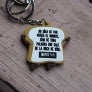 Un llavero divertido con forma de rebanada de pan y con la frase: «Nadie es como tú y ese es tu poder, así que sé tan raro como quieras».