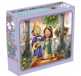 Caja metálica con un rompecabezas para niños de 100 piezas titulado «La reina Ester», en el que aparecen un rey y una reina caricaturizados con un perro en un jardín. Ideal para niños a partir de 6 años.