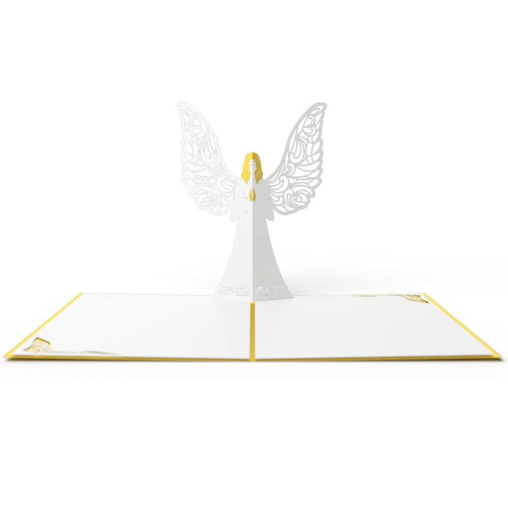 Una tarjeta pop-up de alta calidad, en blanco y dorado, muestra en el centro a un ángel de pie con alas muy detalladas y el pelo rubio amarillento.