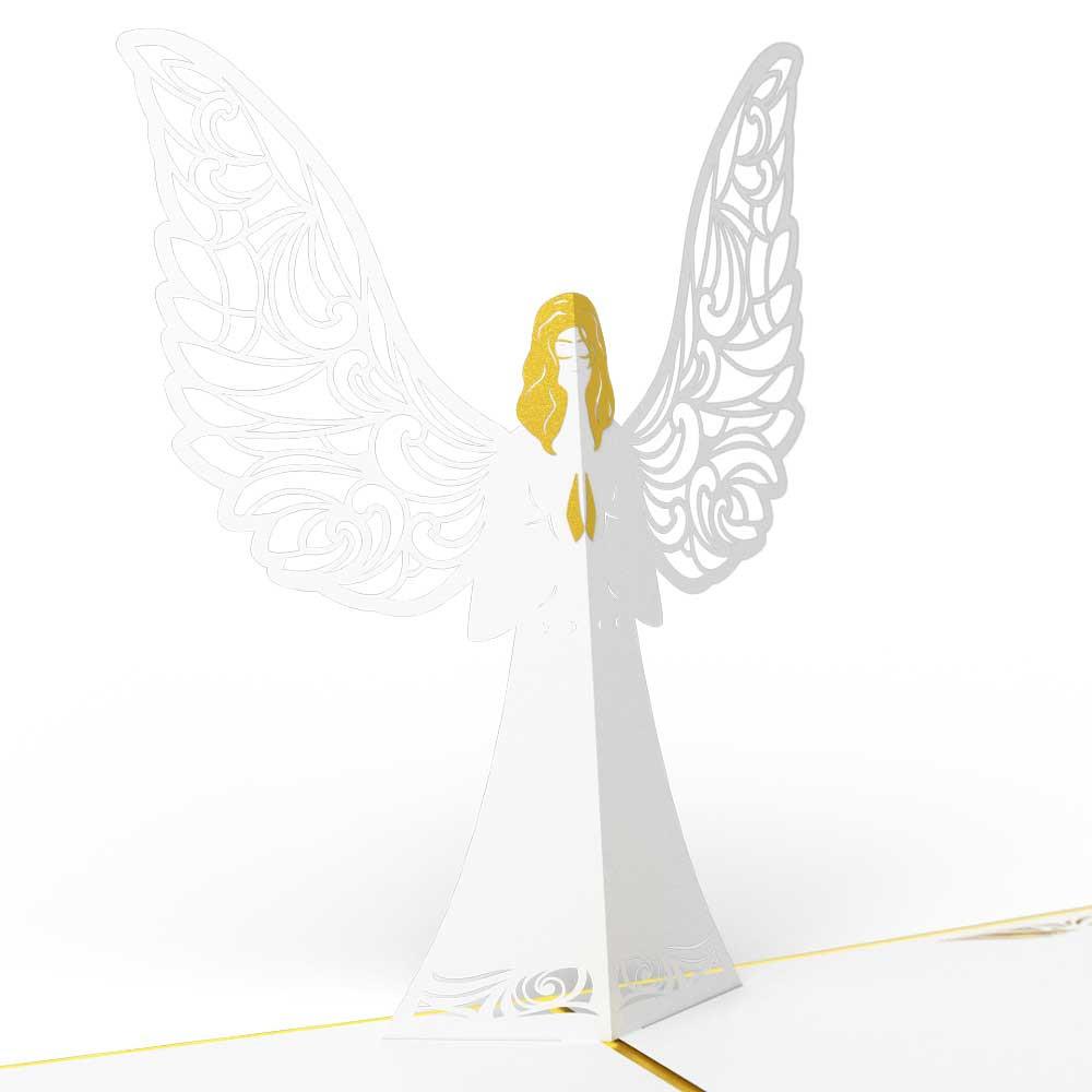 Figurita de papel de color blanco y dorado con un angelito de alas de diseño muy detallado, que se mantiene de pie sobre una superficie plana, con las manos juntas en actitud de oración; ideal como tarjeta de alta calidad o para acompañar una tarjeta de 5 x 7 en ocasiones especiales.