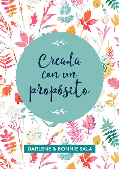Portada de un libro con coloridas ilustraciones florales y un círculo de color verde azulado en el centro en el que aparece el título en español *Creada con un propósito*, un devocional para mujeres sobre el propósito de Dios, de Darlene y Bonnie Sala.