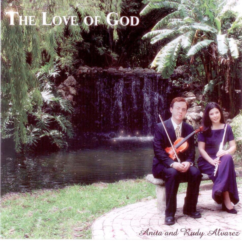 Dos personas vestidas de gala están sentadas en un banco junto a un estanque y una cascada, con violines en las manos, rodeadas de una exuberante vegetación. El texto reza: «El amor de Dios y Anita y Rudy Álvarez». Disfruta de la música instrumental con violín, flauta y piano.