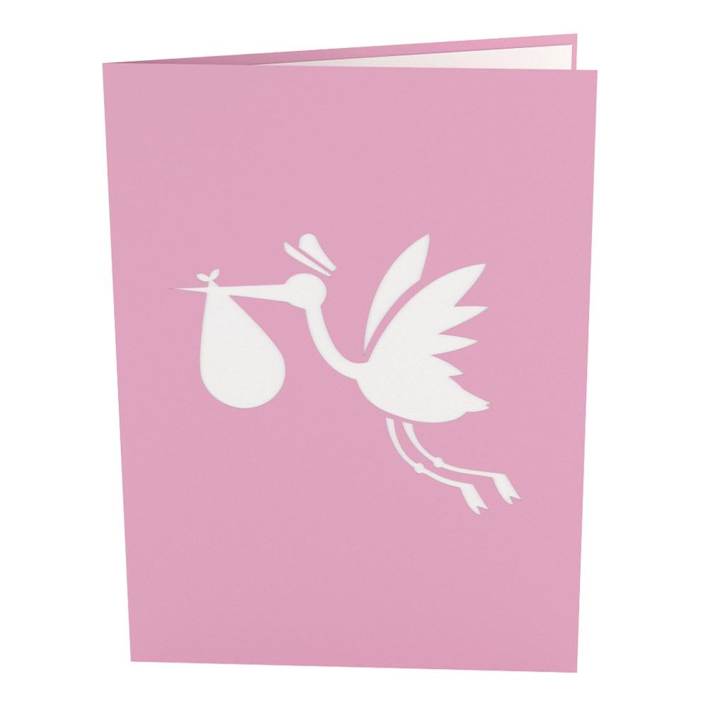 Tarjeta rosa de 5 x 7 con la silueta blanca de una cigüeña que lleva un pañalito en el pico, lo que suele simbolizar la llegada de un bebé.